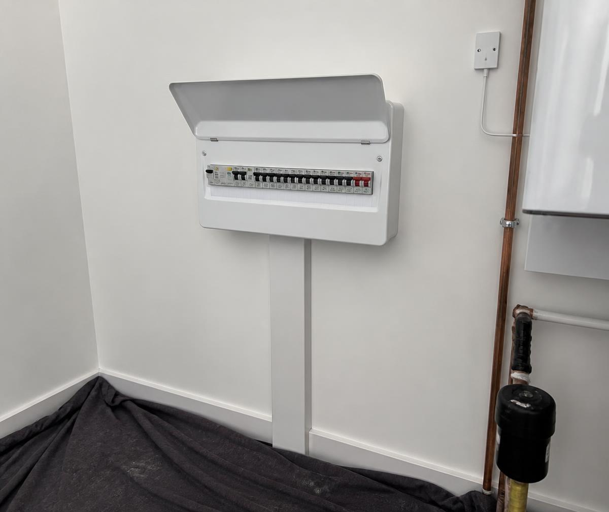 New labelled consumer unit fitted in a UK utility room